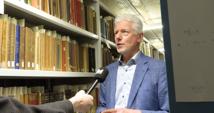 Roman Koot is interviewed inside the special collections in the library