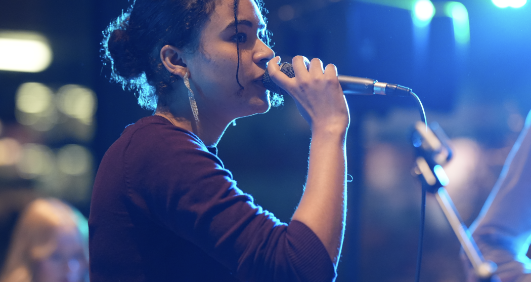 Close-up of woman singing into a microphone